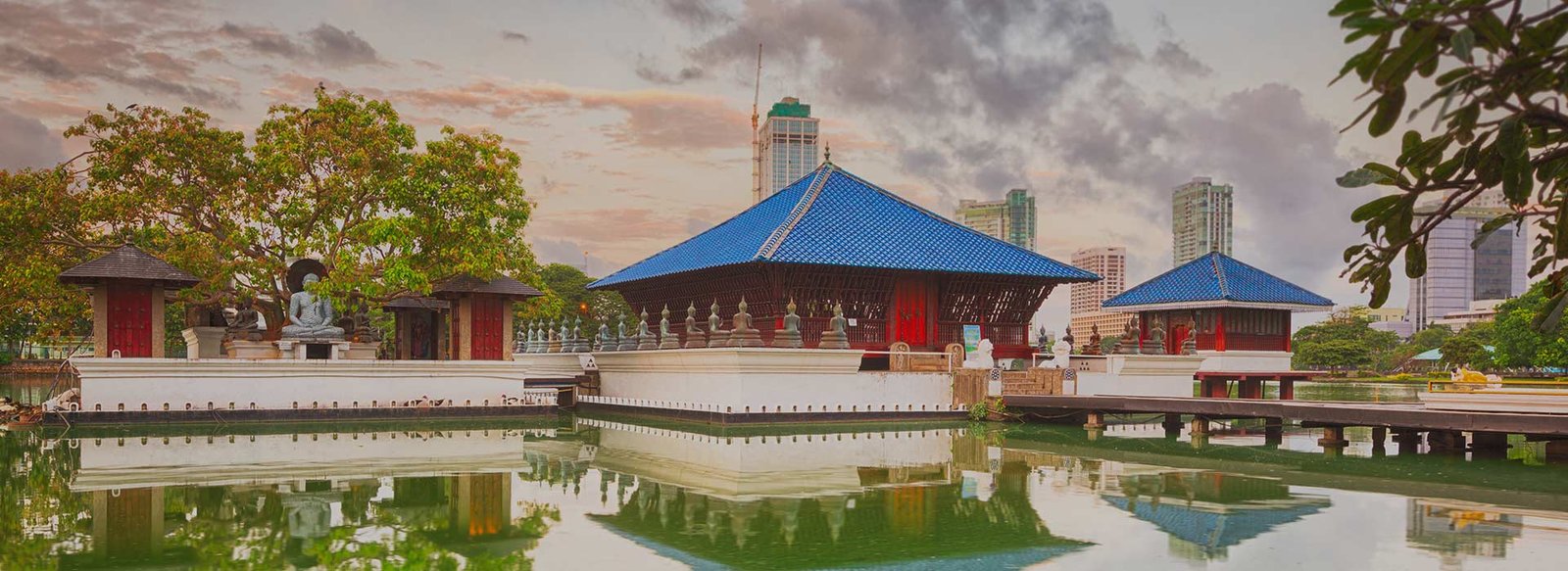 Gangaramaya Temple in Colombo, Sri Lanka, featuring colourful Buddhist statues, traditional architecture, and detailed religious decorations.