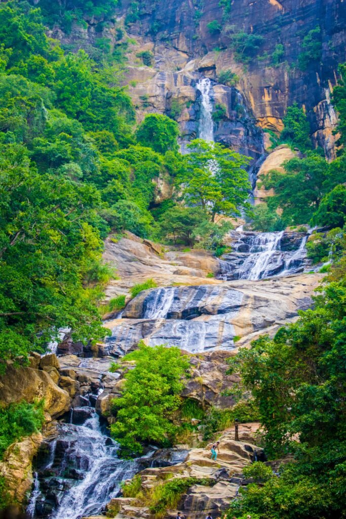 Ravana Waterfall in Ella surrounded by lush green hills